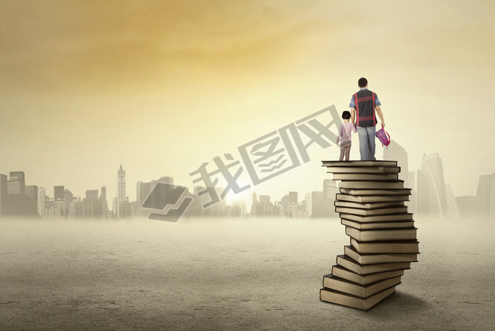 Child and her dad standing on a pile of books