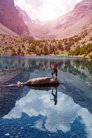 Energetic hiker and mountain lake