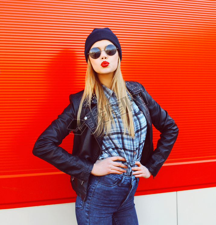 Portrait of fashionable blonde woman blowing lips with red lipst