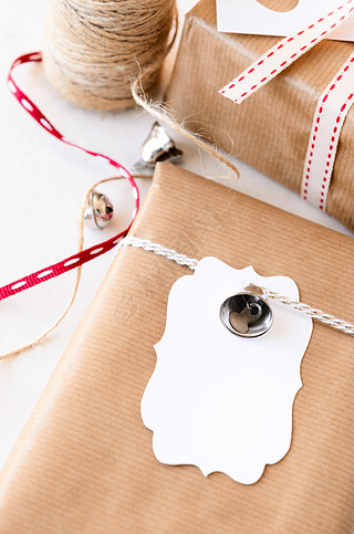 Wrapped gifts decorated with silver bells and gift tags