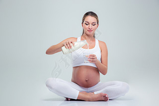 Woman sitting on the floor and drinking milk