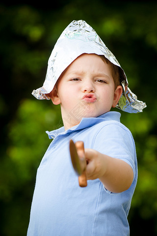 Child playing pirate outdoors in homemade costume