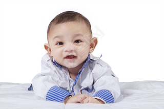 Attractive male infant laughing on bed