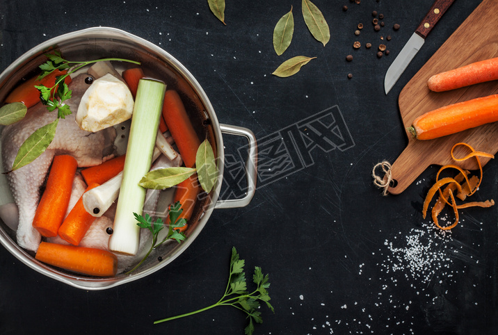 Preparing chicken stock with vegetables in a pot