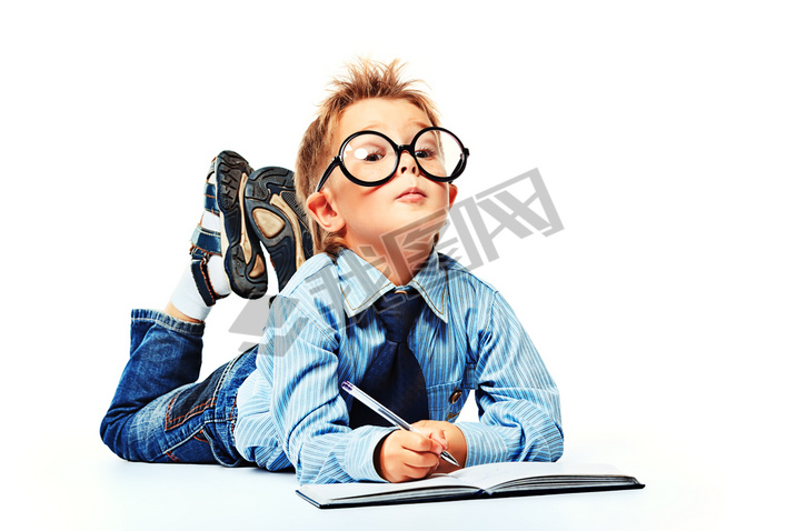 boy in spectacles and suit lying on a floor