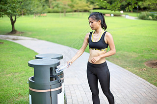 Woman doing recycling in park after run