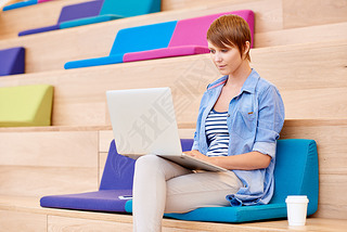 woman working on laptop in open interior