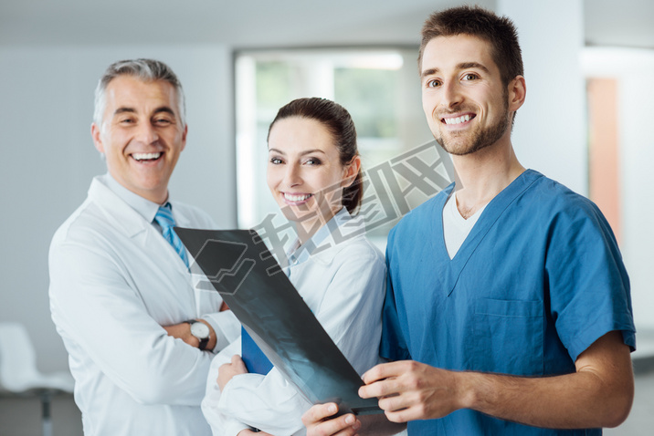 Medical team posing and examining an x-ray image