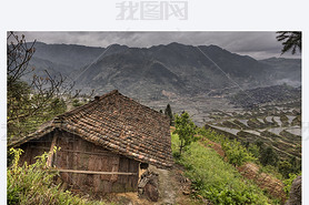 Wooden shed farmers in highlands of China, amid rice fields.