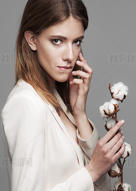 fashion model woman with cotton plant balls in her hands 