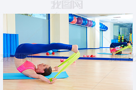 Pilates woman roll over rubber band exercise