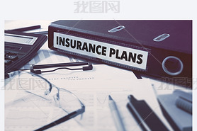 Insurance Plans on Ring Binder. Blured, Toned Image.