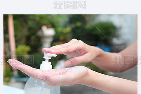 Female hands using gel pump dispenser wash hand sanitizer.