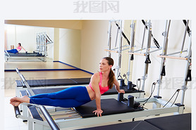 Pilates reformer woman snake twist exercise