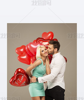 Kissing couple with red balloons