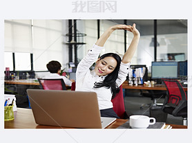 asian business woman stretching arms in office
