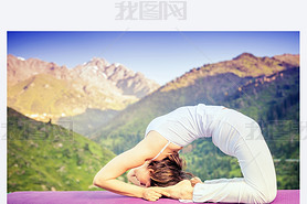 Asian woman doing yoga at mountain