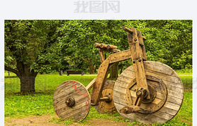 Wooden sculpture bike with three wheels