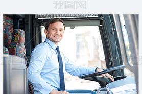 Attractive young man is driving a public transport