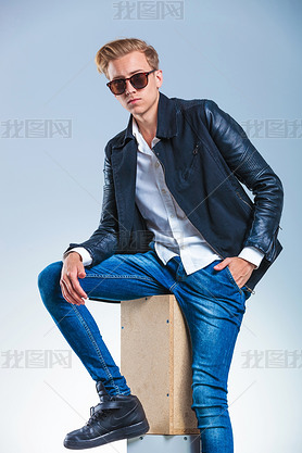guy wearing sunglasses and leather jacket while hing his hand