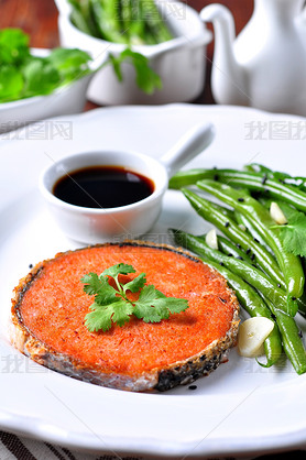 Salmon steak with green beans, garlic, black sesame and soy sauce. Selective focus.