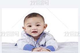 Attractive male infant laughing on bed