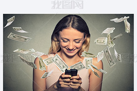 Happy woman using artphone with dollar bills flying away from screen