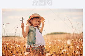 happy child on summer field, spending vacation outdoor, warm rural scene