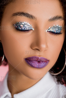 african american girl with silver glitter eyeshadows on closed eyes and purple lips, isolated on pin