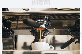 Fresh espresso coffee brewing through the bottomless portafilter