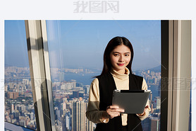 Young Asian woman is holding portable digital tablet