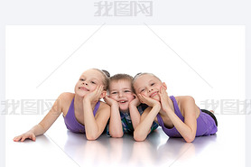 Beautiful girls gymnasts next to his younger brother