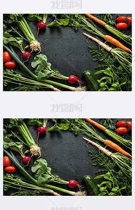 Young spring vegetables on black chalkboard