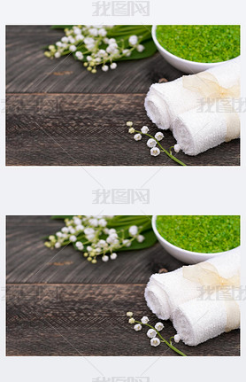 Natural green sea salt and towel for bath and spa on a wooden bo