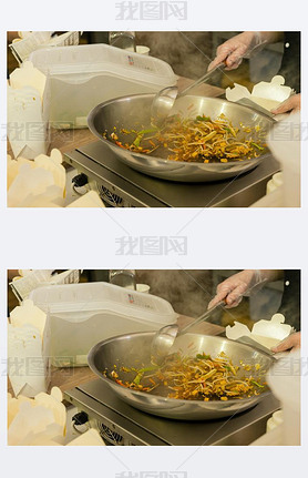 Close Up of Person Cooking Stir Fry in Hot Pan