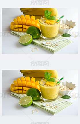 Yellow oothie in glasses with mango and tropical fruits