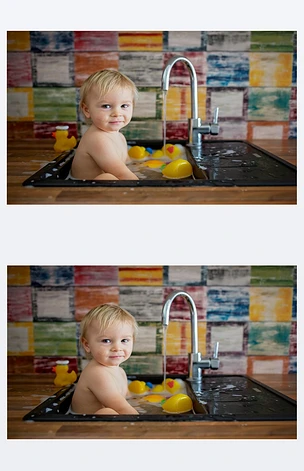 可爱的微笑的婴儿洗澡在厨房水槽。孩子们在阳光明媚的厨房里玩泡沫和肥皂泡, 厨房里有橡胶鸭和玩具。小男孩洗澡, 用水有趣