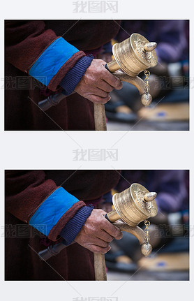 Old Tibetan man holding wooden walking stick and buddhist prayer wheel, Ladakh, India