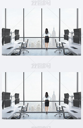 Rear view of a lady in formal suit who is looking out the window in the modern panoramic office with