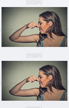 woman pinches nose with fingers looks with disgust away something stinks