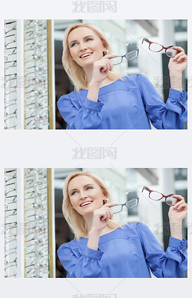 Pretty blond girl is choosing glasses in store