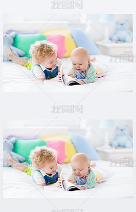 Little brothers reading a book in bed