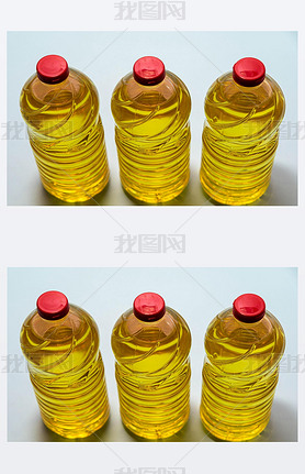 Bottles of edible soy oil on blue background. Olive oil for salads and cooking in general. Soybean o