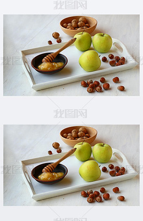 Apples, honey and nuts on a white tray