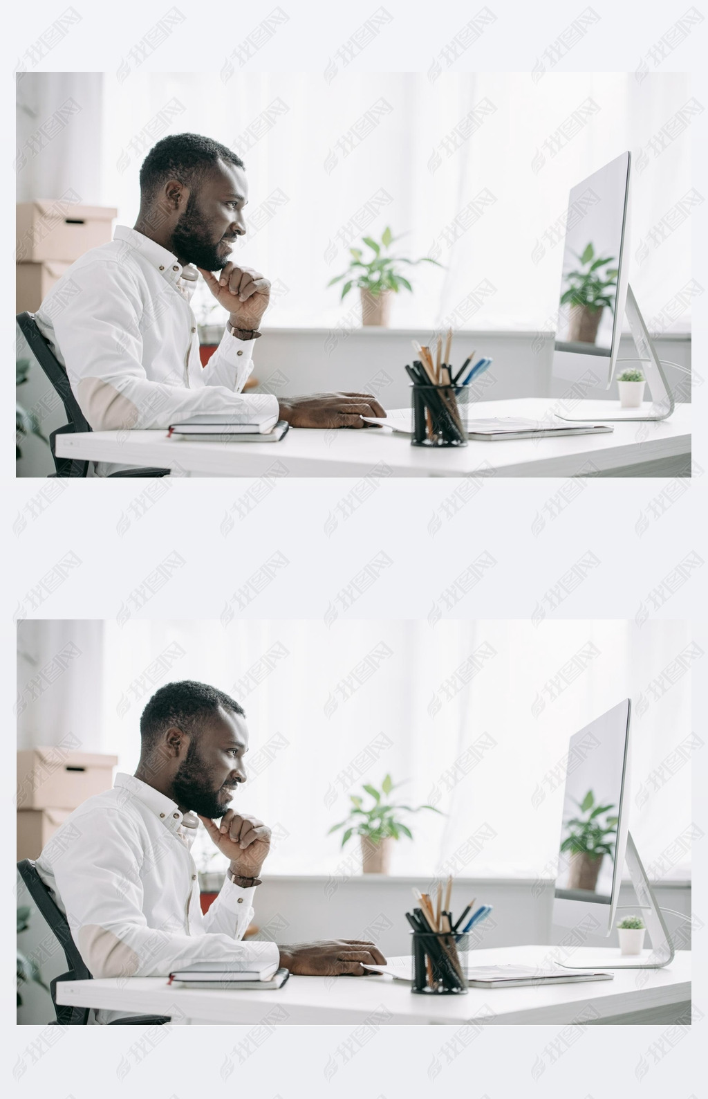 side view of cheerful handsome african american businesan working at computer in office