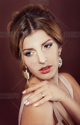 Studio portrait of a beautiful dark blond woman with evening hai