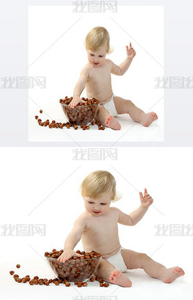 I year old baby playing with hazelnuts