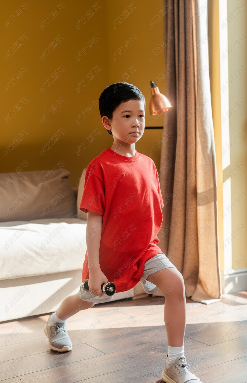 sportive asian boy doing lunges with dumbbells at home during self isolation