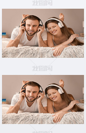 Happy young couple listening to music in bedroom