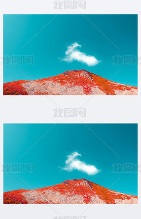 red mountain and cyan blue sky with one cloud